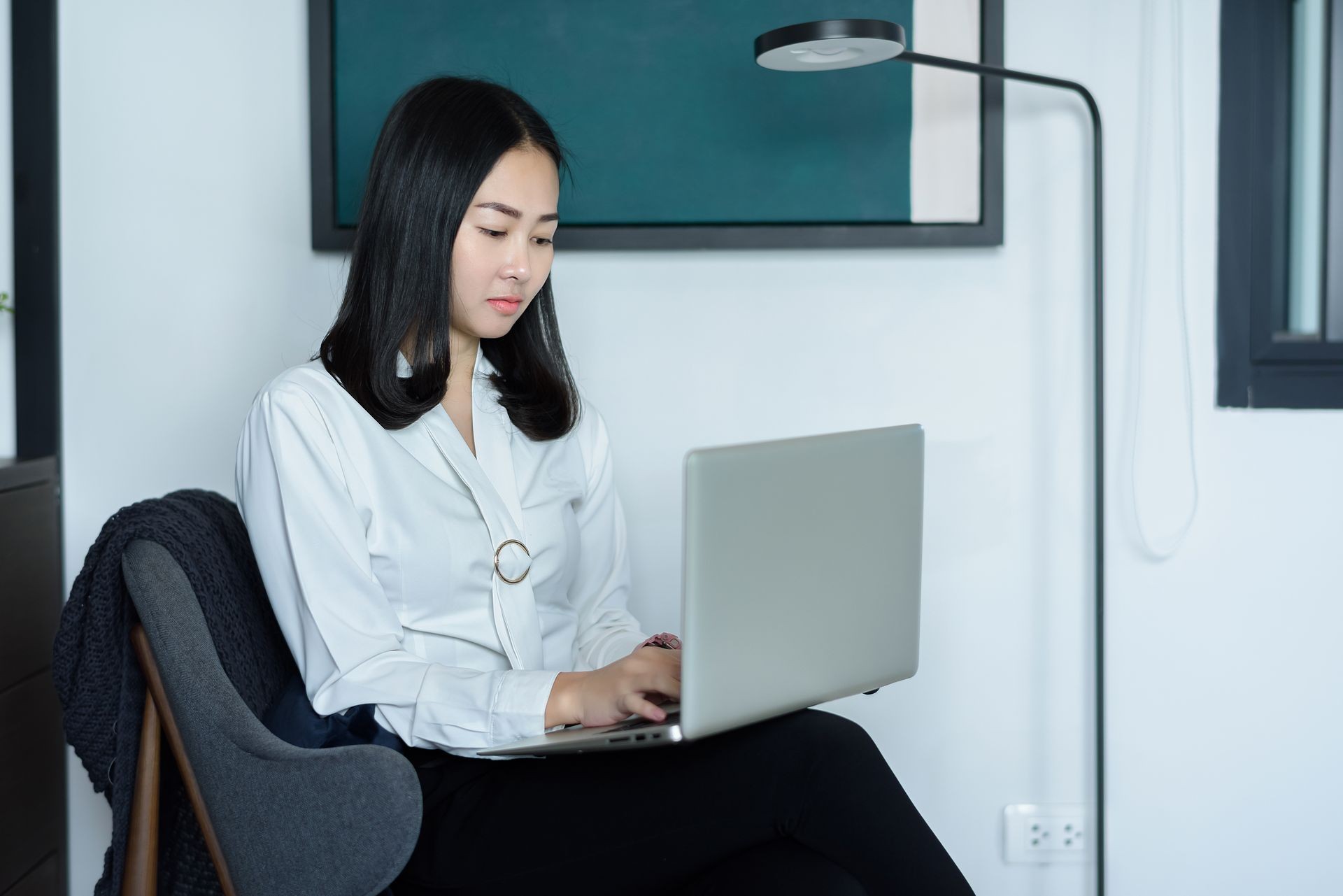 Beautiful Asian businesswoman working with laptop computer at home or modern office